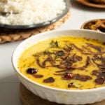 Moong ki daal in a bowl, rice in the background