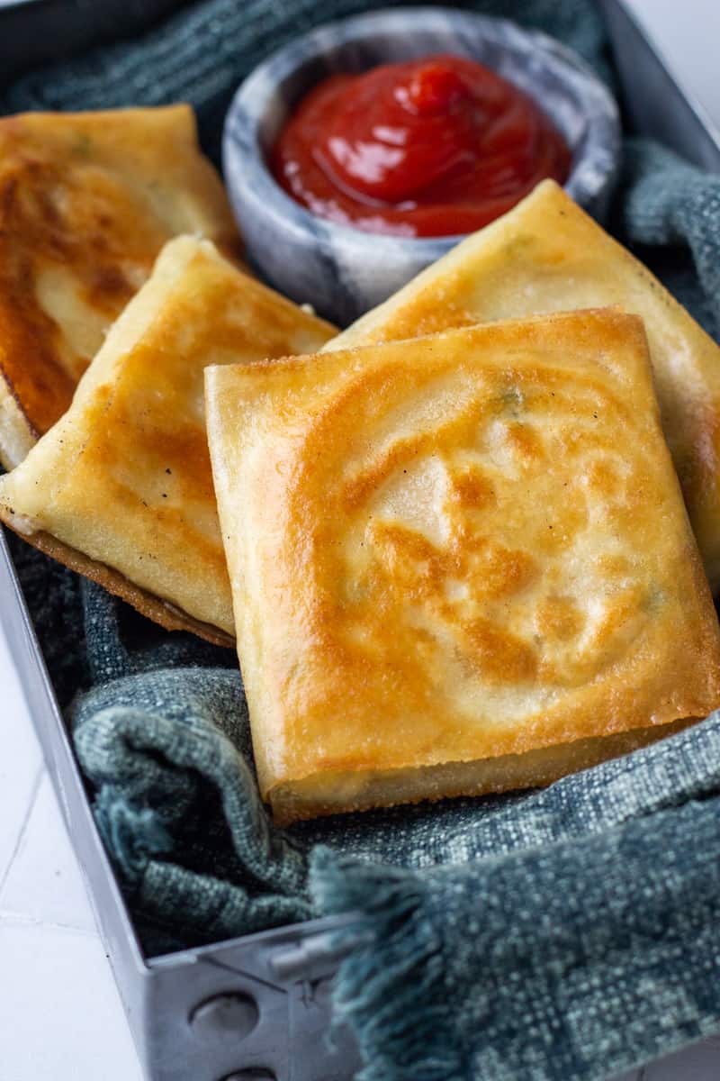 Box Patties in a metal tray with ketchup