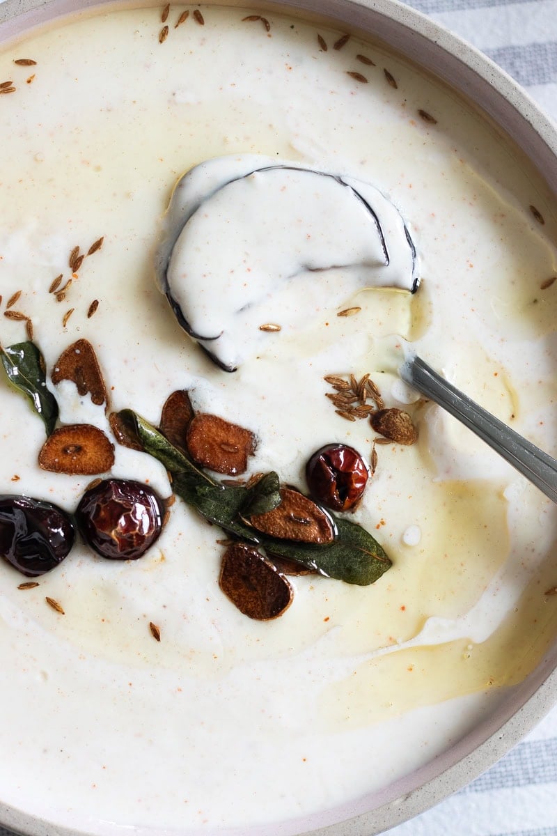 top down view of dahi baingan with the baghaar ingredients in focus