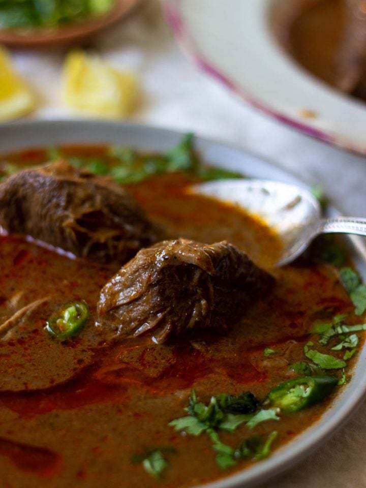 a bowl of nihari with a spoon in it