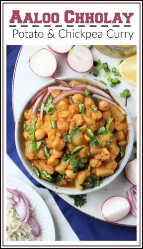 A Pakistani recipe for a spiced potato and chickpea curry. A bowl of the curry with sliced onions, cilantro and green chilies.