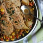 a Platter with Lemon Chicken Roast in it and a spoon resting in some broth
