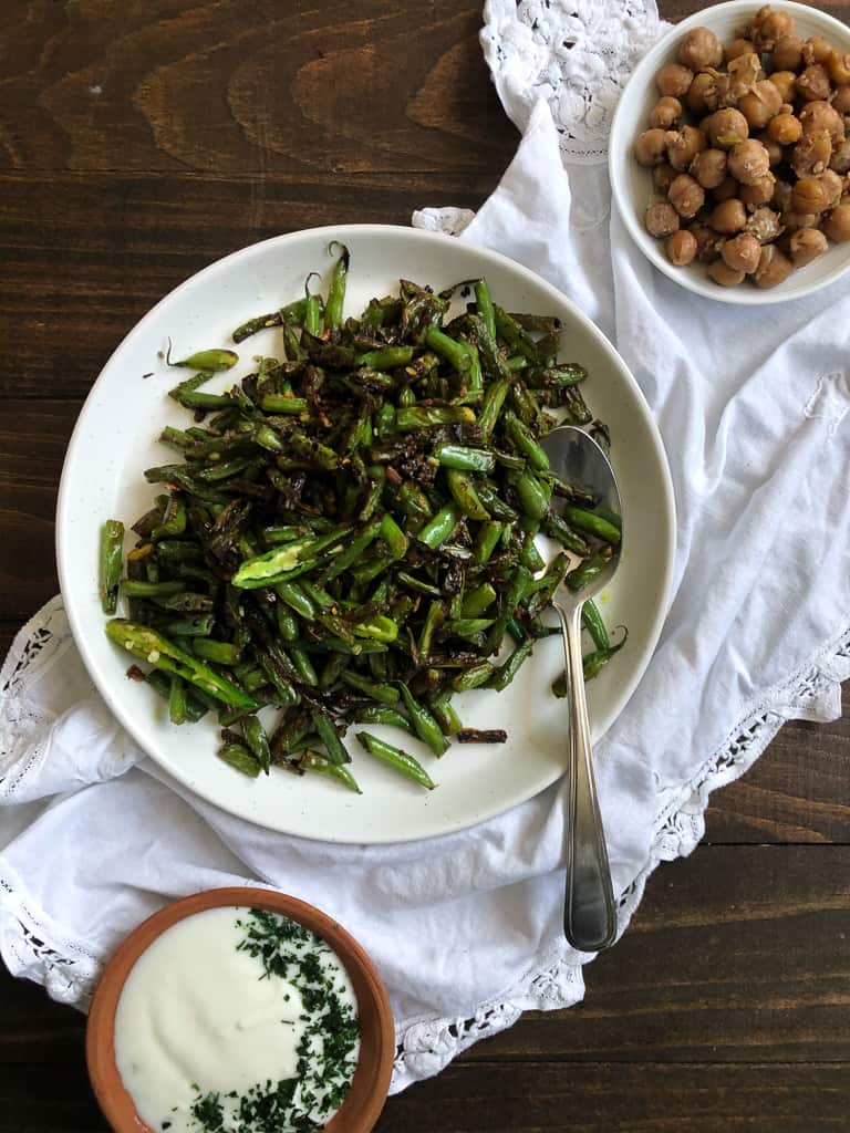 Green bean sabzi, two smaller dishes with chickpeas and yogurt