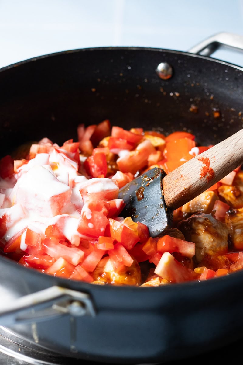 tomatoes and yoghurt added to chicken masala base