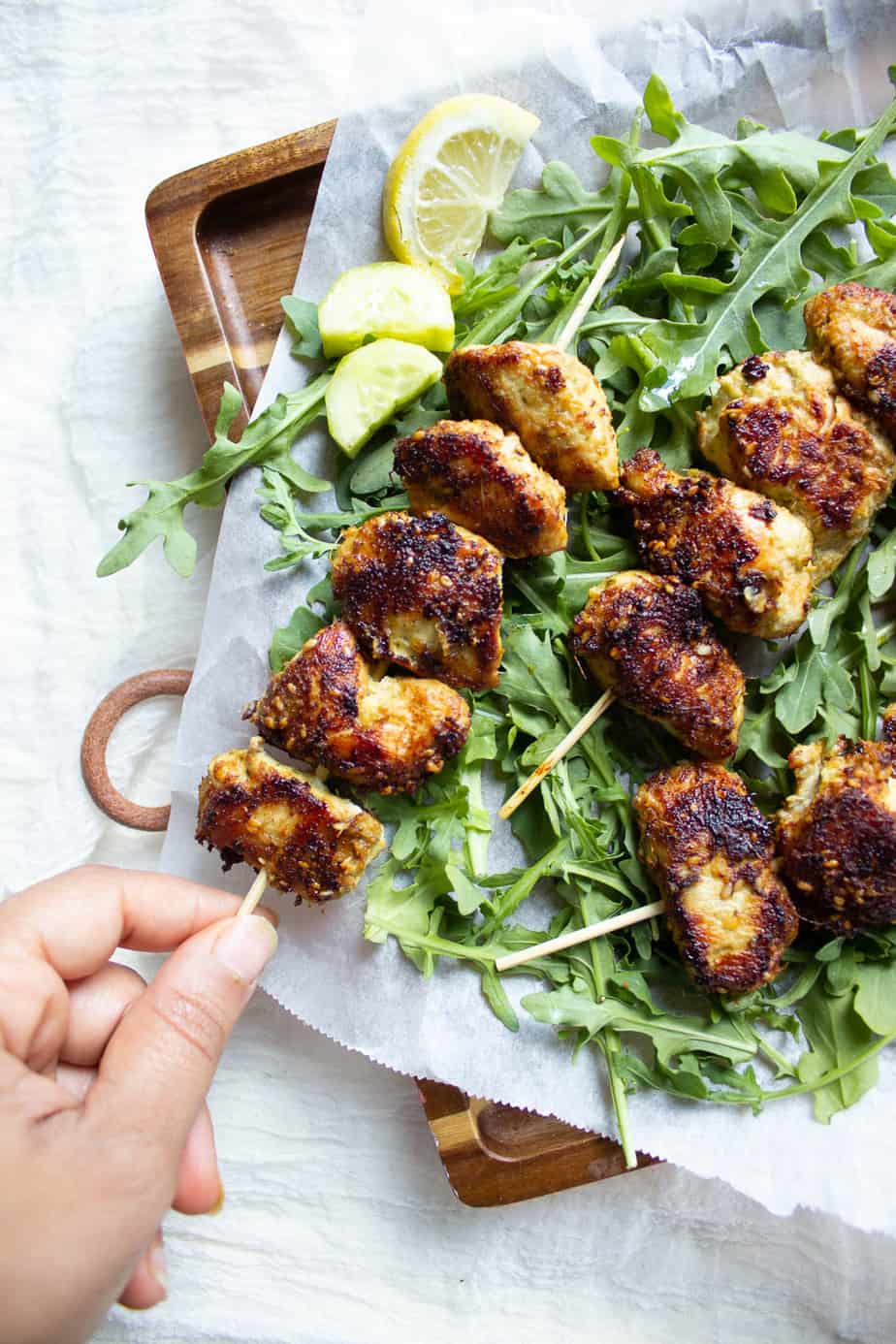 Sesame Ginger Chicken Skewers, one being picked up
