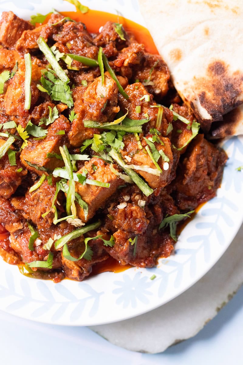 boneless chicken masala with a triangle of roti