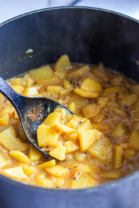 aloo poori aloo in a black pot