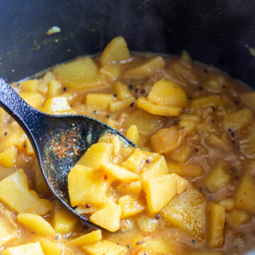 aloo poori aloo in a black pot