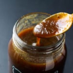 Imli Chutney dripping into a jar with a spoon