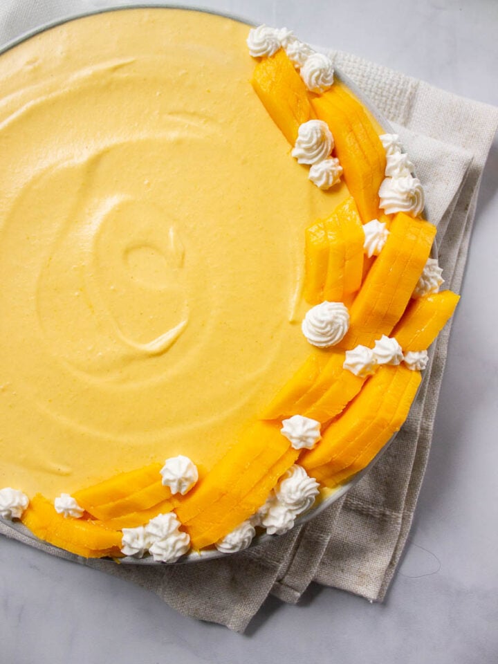Easy Mango Mousse decorated with mangoes and whipped cream