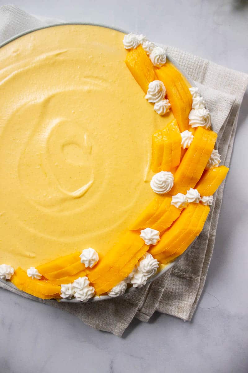 Easy Mango Mousse decorated with mangoes and whipped cream