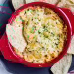 Corn dip with chips around it and one inside