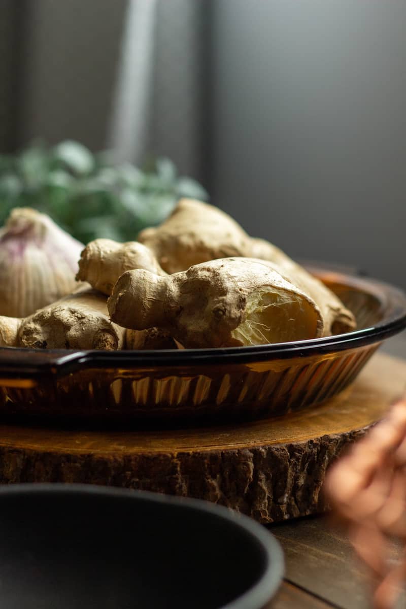 a plate with whole ginger and garlic
