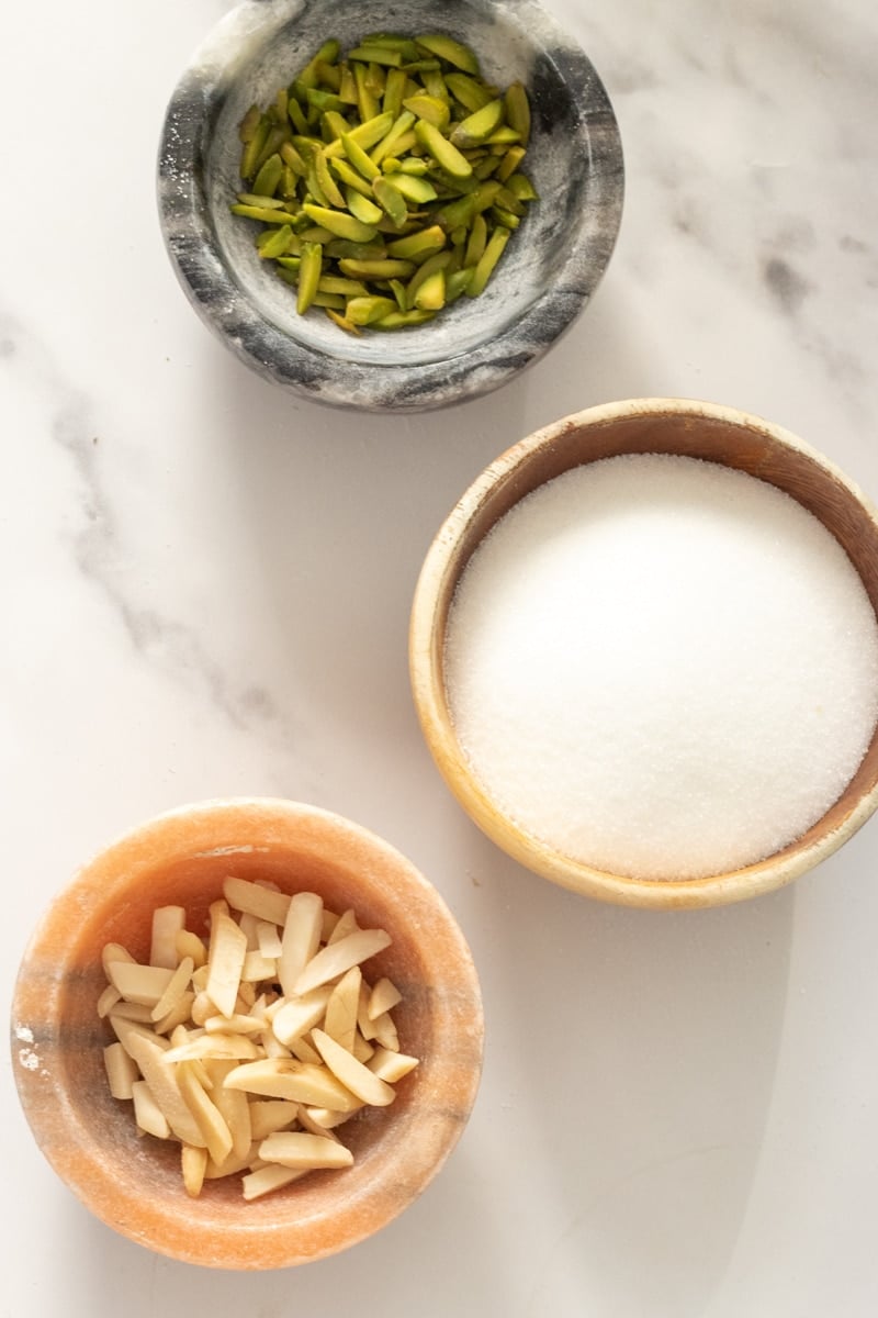 two small bowls with nuts, one with sugar