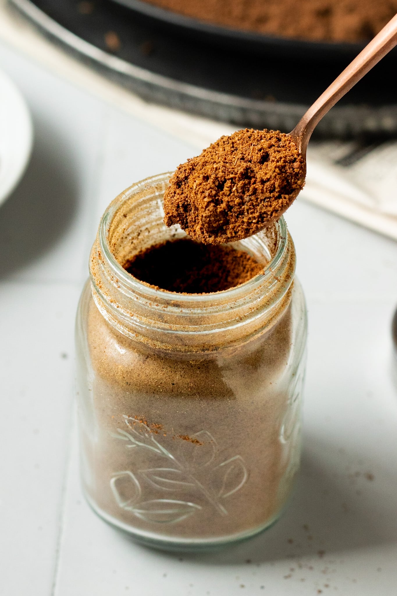 Garam Masala on a spoon in a jar