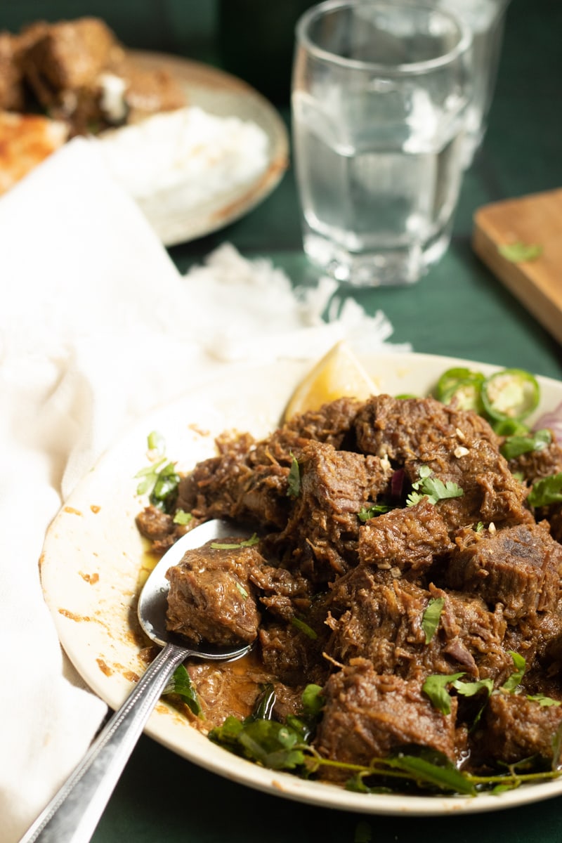 Tala Hua gosht, partial plate view with a spoon on it