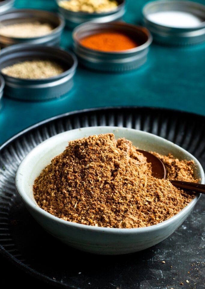 Pakistani Chaat Masala mix in a bowl, spices in background