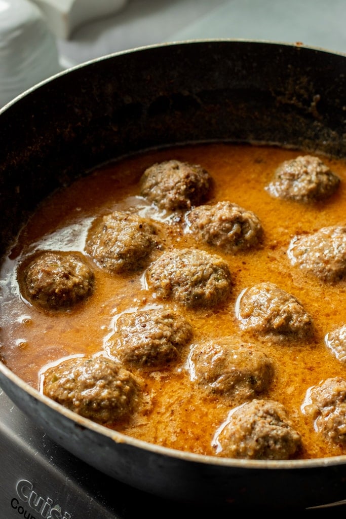 koftay simmered in Pakistani yogurt gravy with oil separation