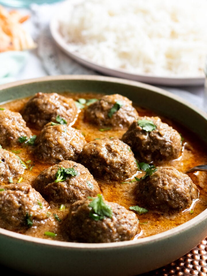 A dish of Kofta Curry garnished with cilantro
