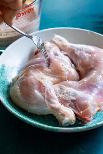 chicken being pierced with a fork
