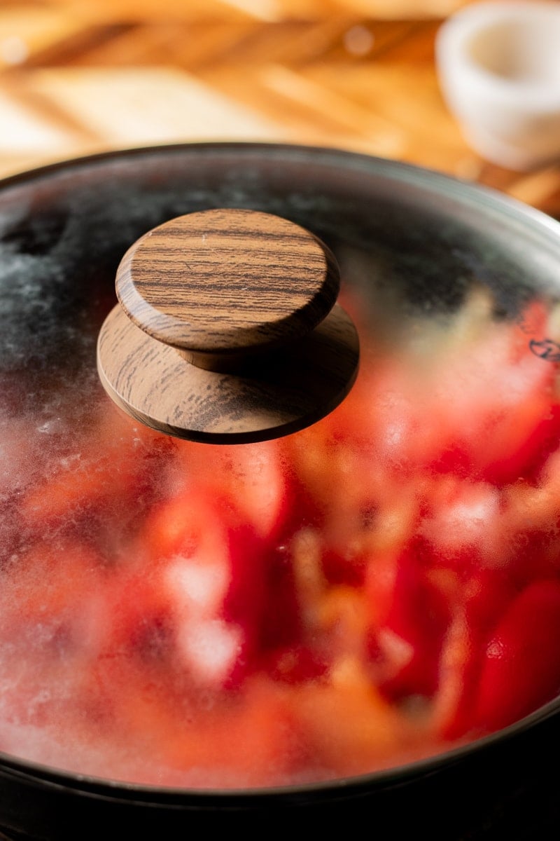 covered pot with tomato masala inside