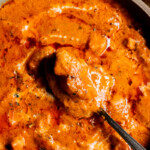 Close up of a dish of Chicken Handi with a spoon in it