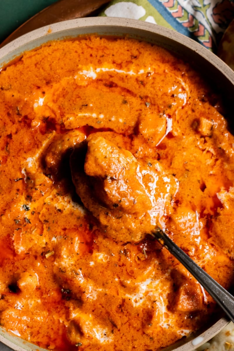 a dish of Chicken Handi with a spoon in it