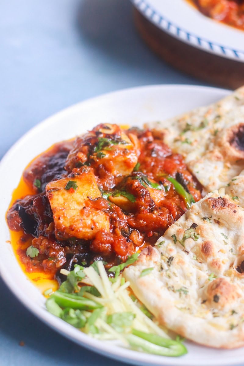 fish karahi on a plate with naan